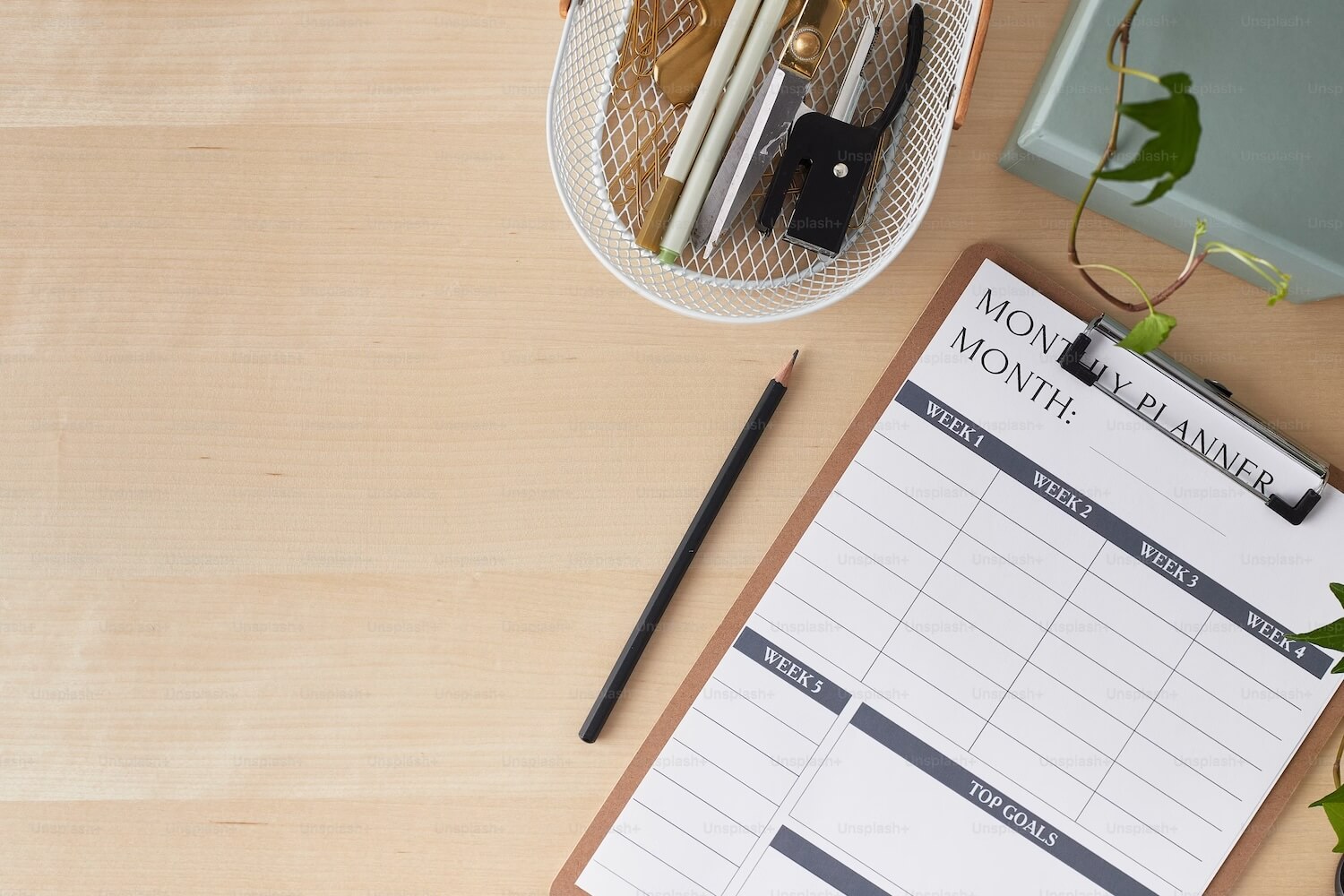 A calendar and some pencils on a desk